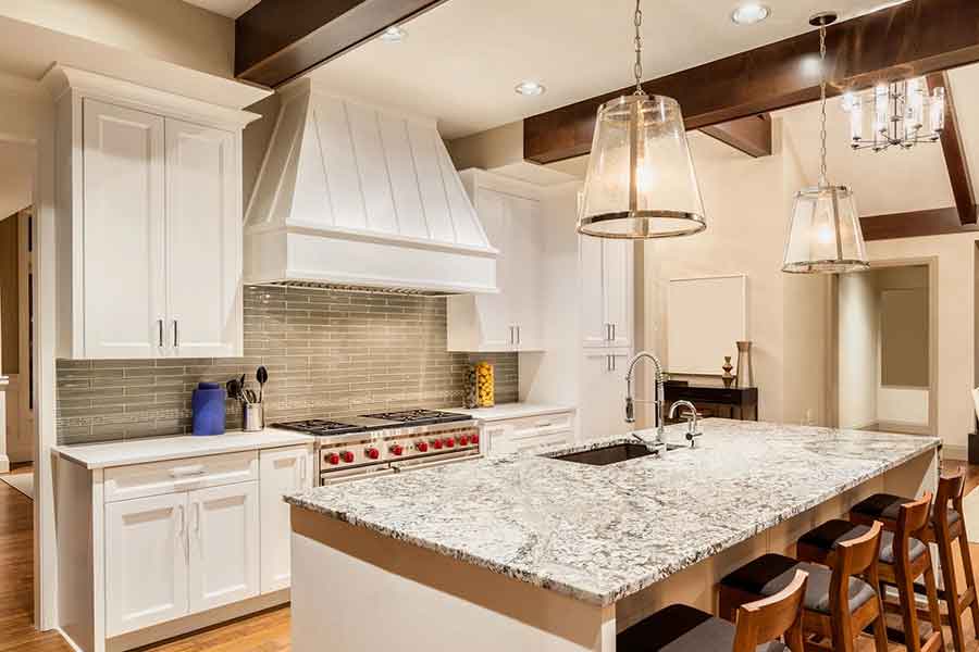 Kitchen with Island, Sink, Cabinets, and Hardwood Floors in new house